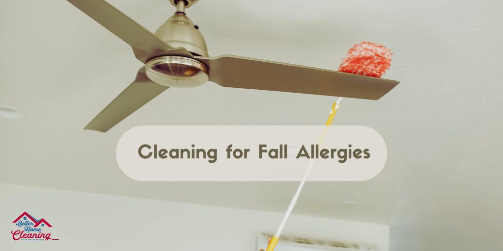 Better Home cleaner using a duster to clean a ceiling fan blade.